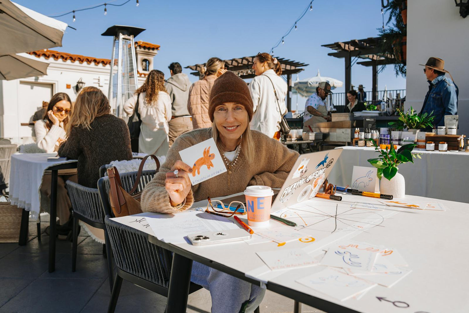 Woman making chart readings with other people in the background.